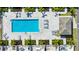 Aerial view of a community pool surrounded by palm trees, lounge chairs, and covered tables at 743 Driving Range Ct, Reunion, FL 34747