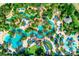 Stunning aerial view of a resort's lazy river, pools, and lush tropical landscaping at 743 Driving Range Ct, Reunion, FL 34747