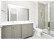 Modern bathroom features a double sink vanity and glass-enclosed shower at 743 Driving Range Ct, Reunion, FL 34747