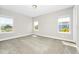 Spacious bedroom with neutral carpet and three bright windows at 743 Driving Range Ct, Reunion, FL 34747