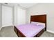 Bedroom features carpeted floors, wooden bed, and closet at 743 Driving Range Ct, Reunion, FL 34747