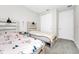 Bedroom with two twin beds and light gray carpeted floors at 743 Driving Range Ct, Reunion, FL 34747