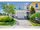 Charming townhome with a two-car garage, stone accents and a well-manicured front yard at 743 Driving Range Ct, Reunion, FL 34747