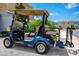 Yamaha golf cart featuring tan leather seats, luggage carrier, and chrome wheels is ready to be driven on sunny days at 743 Driving Range Ct, Reunion, FL 34747