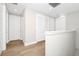 Bright hallway features wood-look floors and several white doors at 743 Driving Range Ct, Reunion, FL 34747