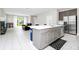 Open concept kitchen with island, stainless steel appliances, and a seamless flow to the living area at 743 Driving Range Ct, Reunion, FL 34747