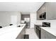 Modern kitchen featuring gray cabinetry, stainless steel appliances, and a large island at 743 Driving Range Ct, Reunion, FL 34747