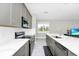 Modern kitchen with stainless steel appliances, granite countertops, and stylish gray cabinetry at 743 Driving Range Ct, Reunion, FL 34747
