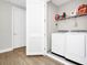 Convenient laundry room with modern appliances and storage shelves at 743 Driving Range Ct, Reunion, FL 34747