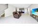 Open-concept living room and kitchen, featuring modern decor, tile floors, and stainless steel appliances at 743 Driving Range Ct, Reunion, FL 34747