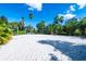 Beach volleyball court surrounded by palm trees, perfect for outdoor recreation at 743 Driving Range Ct, Reunion, FL 34747