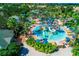 Fun water park with slides, pools, and play areas surrounded by lush greenery at 743 Driving Range Ct, Reunion, FL 34747