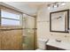 Bright bathroom featuring a glass shower door, tiled walls, and a modern vanity with ample lighting at 854 Mendoza Dr, Kissimmee, FL 34758