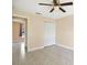 Bedroom featuring tile floors, a ceiling fan, neutral walls and trim, and a closet with bifold doors at 854 Mendoza Dr, Kissimmee, FL 34758
