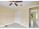 Bedroom featuring tile floors, a ceiling fan, neutral walls and trim, and a closet with bifold doors at 854 Mendoza Dr, Kissimmee, FL 34758