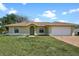 Charming single-story home with arched windows, attached two-car garage and brick paver driveway at 854 Mendoza Dr, Kissimmee, FL 34758