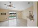 Bright living area featuring tile flooring and a sliding glass door overlooking a refreshing private pool at 854 Mendoza Dr, Kissimmee, FL 34758