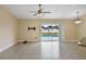 Open living area with tile floors, ceiling fan, and sliding glass doors with view of the pool at 854 Mendoza Dr, Kissimmee, FL 34758