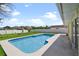 Backyard featuring a pool, a white fence, green grass and landscaping, and a blue sky with clouds at 854 Mendoza Dr, Kissimmee, FL 34758