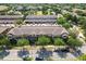 Aerial view of townhomes in a residential area with mature trees and well-maintained landscaping at 9112 Grey Moss Dr, Orlando, FL 32832