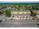 Overhead perspective of townhomes featuring garages and ample parking spaces, surrounded by lush greenery at 9112 Grey Moss Dr, Orlando, FL 32832