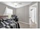 Bedroom with a desk, a window with blinds, and an open doorway at 9112 Grey Moss Dr, Orlando, FL 32832