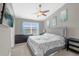 Spacious bedroom with a large window, blue curtains, and a ceiling fan at 9112 Grey Moss Dr, Orlando, FL 32832