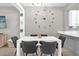 Dining room with white table, black chairs, and decorative wall clock at 9112 Grey Moss Dr, Orlando, FL 32832