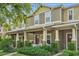 Townhome exterior with covered porch, columns, and tidy landscaping at 9112 Grey Moss Dr, Orlando, FL 32832