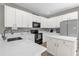 Modern kitchen with white cabinets, stainless steel appliances, and granite countertops at 9112 Grey Moss Dr, Orlando, FL 32832