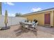 Charming brick patio with outdoor dining set and umbrella, perfect for entertaining or enjoying the outdoors at 9112 Grey Moss Dr, Orlando, FL 32832