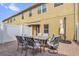 Inviting brick patio with outdoor dining set and umbrella, ideal for relaxing and outdoor gatherings at 9112 Grey Moss Dr, Orlando, FL 32832