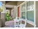 Cozy front porch with table, chairs, and brick flooring at 9112 Grey Moss Dr, Orlando, FL 32832