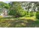 Large backyard features mature trees and a playset at 9681 Lake Douglas Pl, Orlando, FL 32817