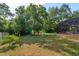 Expansive backyard with mature trees, playset, screened-in pool, and private setting at 9681 Lake Douglas Pl, Orlando, FL 32817