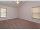 Spacious bedroom with ceiling fan and two windows for plenty of natural light at 9681 Lake Douglas Pl, Orlando, FL 32817