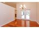 Open dining area featuring gleaming wood floors, a modern chandelier and easy access to the outdoor patio at 9681 Lake Douglas Pl, Orlando, FL 32817