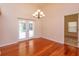 Elegant dining room with wood floors and a chandelier, with easy access to the outdoor patio at 9681 Lake Douglas Pl, Orlando, FL 32817