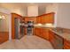 Well-equipped kitchen featuring stainless steel appliances and handsome wood cabinets at 9681 Lake Douglas Pl, Orlando, FL 32817