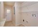 Functional laundry room with tile flooring, utility sink, and washer/dryer hookups at 9681 Lake Douglas Pl, Orlando, FL 32817