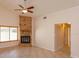 Living room features a brick fireplace, ceiling fan, and light tile floors at 9681 Lake Douglas Pl, Orlando, FL 32817