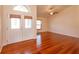 Bright, open living room features gleaming wood floors and abundant natural light from large windows at 9681 Lake Douglas Pl, Orlando, FL 32817
