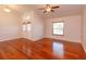 Spacious living room featuring elegant wood floors, a ceiling fan, and natural light from the front door at 9681 Lake Douglas Pl, Orlando, FL 32817