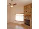Living room with light tile flooring, fireplace, and ceiling fan at 9681 Lake Douglas Pl, Orlando, FL 32817