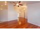 Open-concept living area with gleaming wood floors and high ceilings, perfect for entertaining and relaxation at 9681 Lake Douglas Pl, Orlando, FL 32817