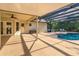 Covered patio with a screened-in pool and ample seating area at 9681 Lake Douglas Pl, Orlando, FL 32817