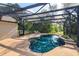 Inviting screened pool area, perfect for relaxing or entertaining, with lush landscaping at 9681 Lake Douglas Pl, Orlando, FL 32817