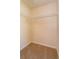 Compact walk-in closet with shelving and plush beige carpeting at 9681 Lake Douglas Pl, Orlando, FL 32817