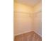 Small walk-in closet featuring beige carpet and built-in shelving at 9681 Lake Douglas Pl, Orlando, FL 32817