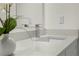 Bathroom vanity featuring chrome faucet, quartz countertop, and flower accent at 9919 Cypress Park Dr, Orlando, FL 32824